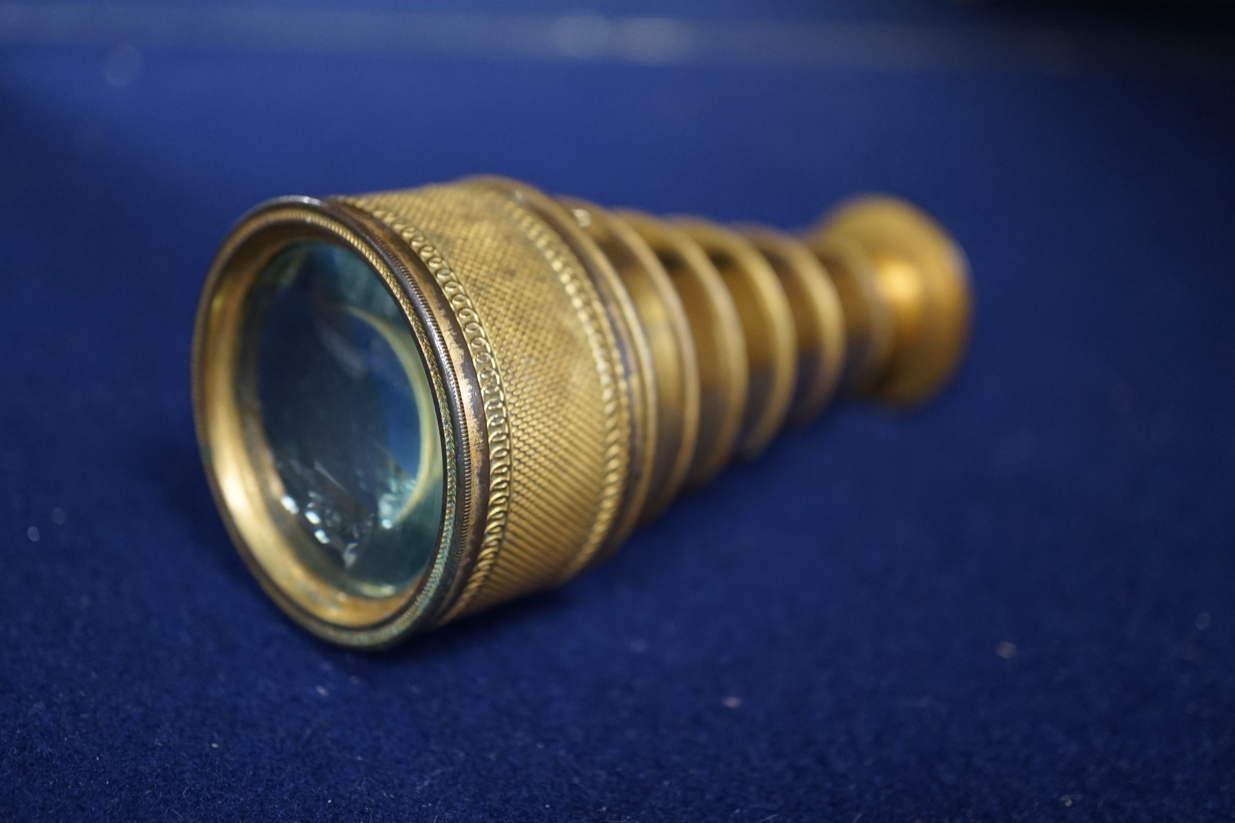 A 19th century gilt brass six drawer monocular telescope by Dollond, London, 10cm fully extended. Condition - fair, some wear to gilt finish.